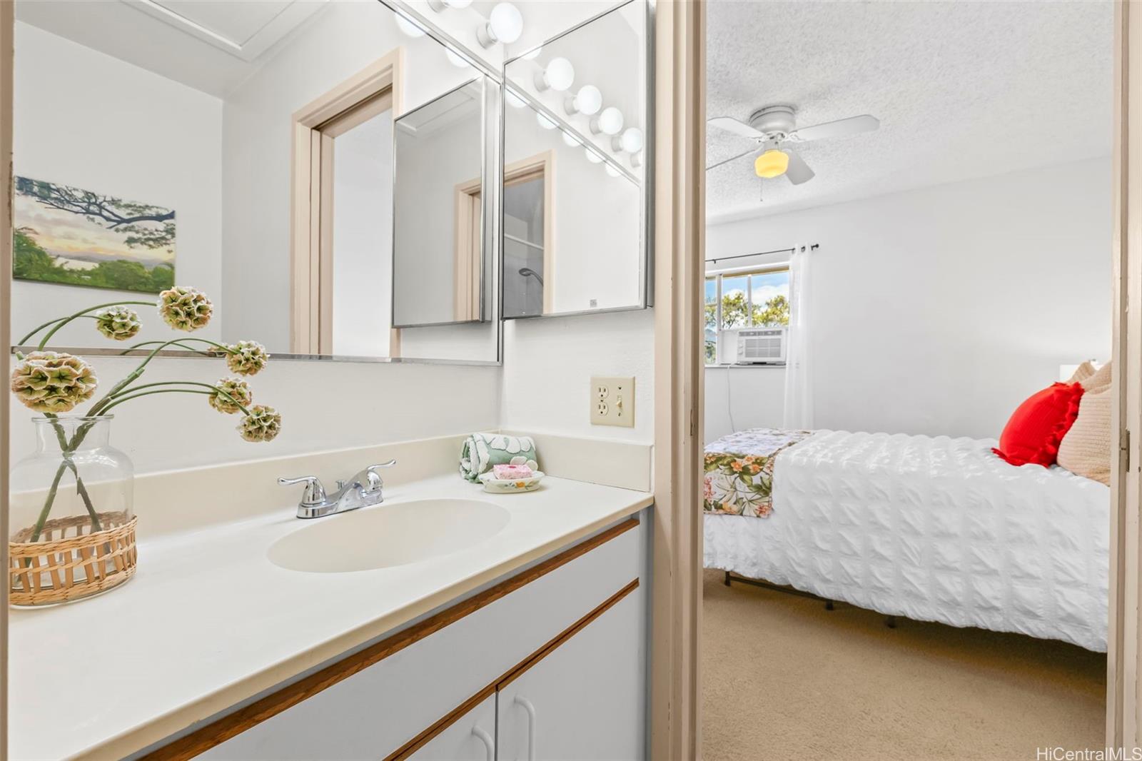 91-1008 Makaaloa Street, Unit 3E Ewa Beach, HI 96706 - Photo 4 of 21 a bedroom with a bed and a sink