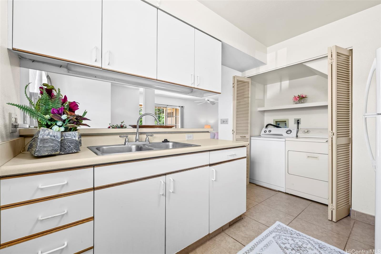 91-1008 Makaaloa Street, Unit 3E Ewa Beach, HI 96706 - Photo 6 of 21 a kitchen with cabinets and window