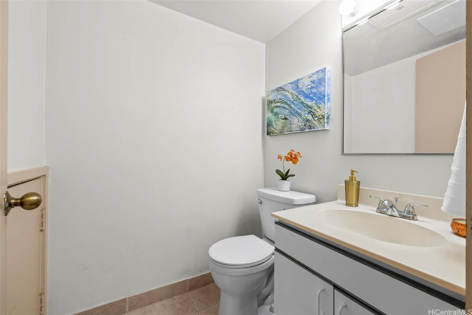 91-1008 Makaaloa Street, Unit 3E Ewa Beach, HI 96706 - Photo 8 of 21 a bathroom with a sink and a toilet