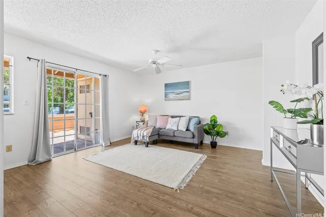 a living room with furniture and a potted plant