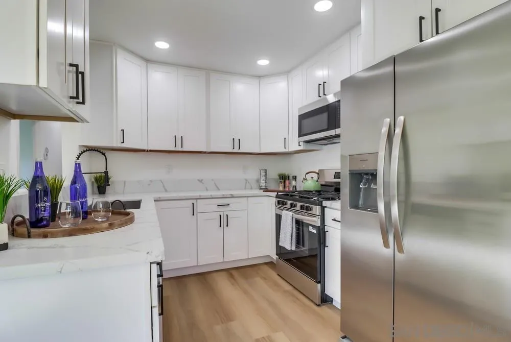 2821-25 Rosedale Way Spring Valley, CA 91977 - Photo 15 of 72 a kitchen with stainless steel appliances granite countertop a refrigerator and a stove top oven