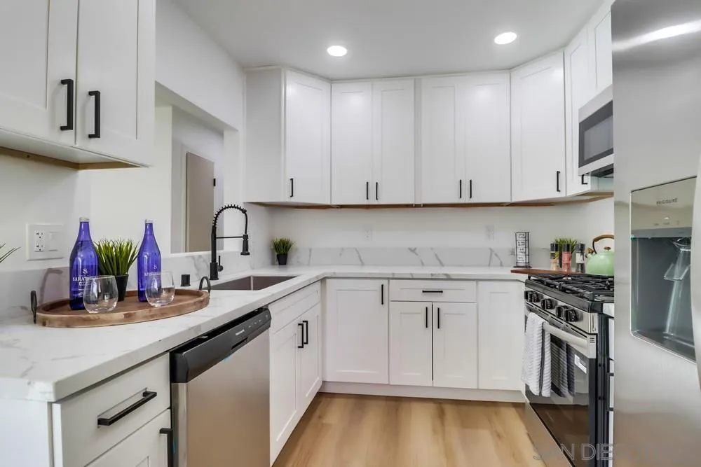 2821-25 Rosedale Way Spring Valley, CA 91977 - Photo 16 of 72 a kitchen with cabinets appliances and a counter space