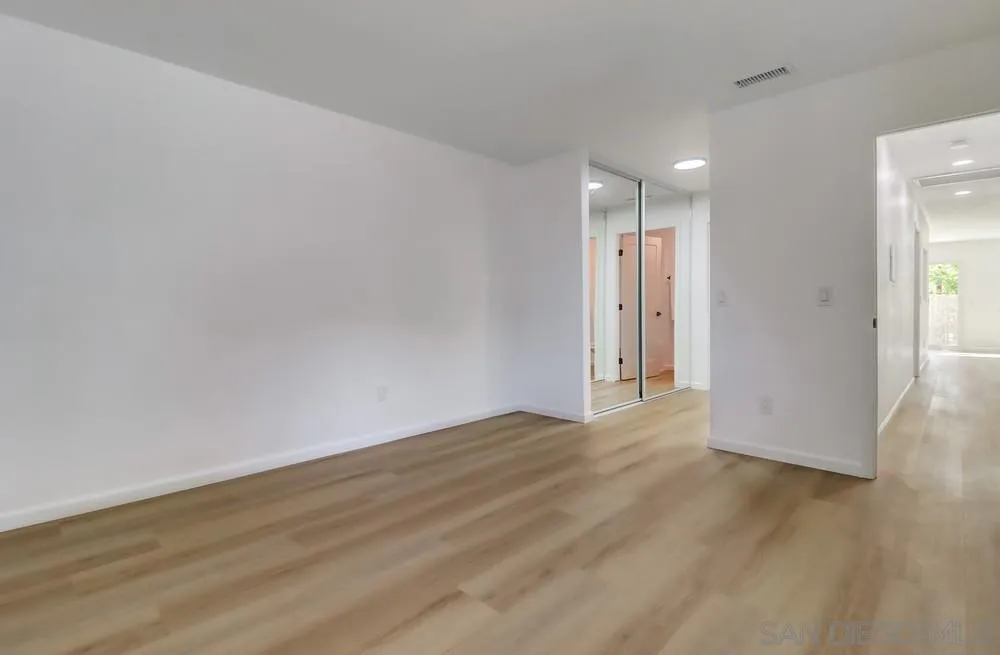 2821-25 Rosedale Way Spring Valley, CA 91977 - Photo 25 of 72 a view of an empty room with wooden floor and closet