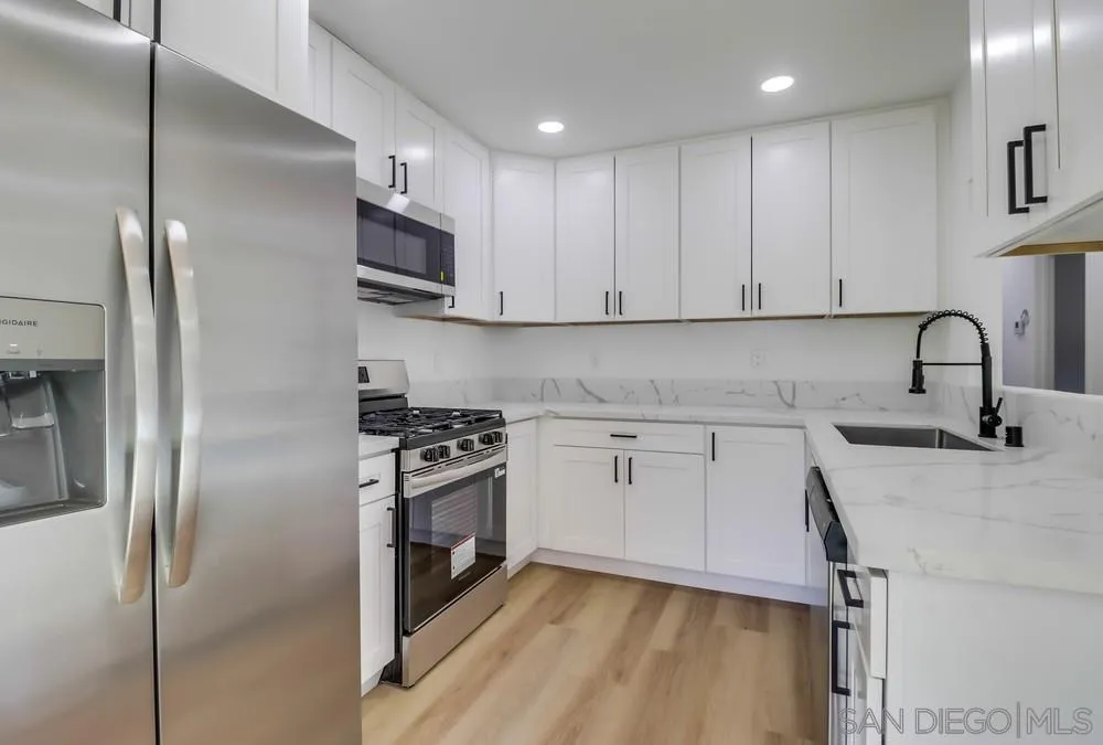 2821-25 Rosedale Way Spring Valley, CA 91977 - Photo 33 of 72 a kitchen with stainless steel appliances granite countertop a sink stove and refrigerator