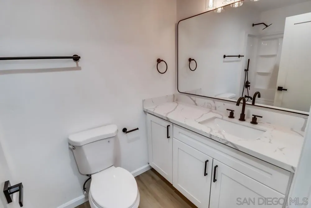2821-25 Rosedale Way Spring Valley, CA 91977 - Photo 57 of 72 a bathroom with a granite countertop toilet sink and mirror