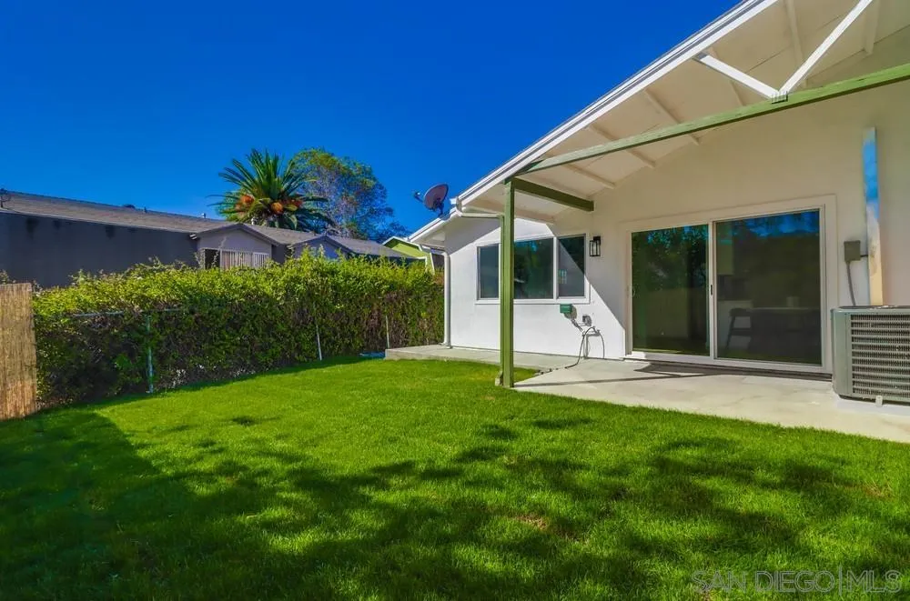 2821-25 Rosedale Way Spring Valley, CA 91977 - Photo 72 of 72 a front view of a house with a yard and garage