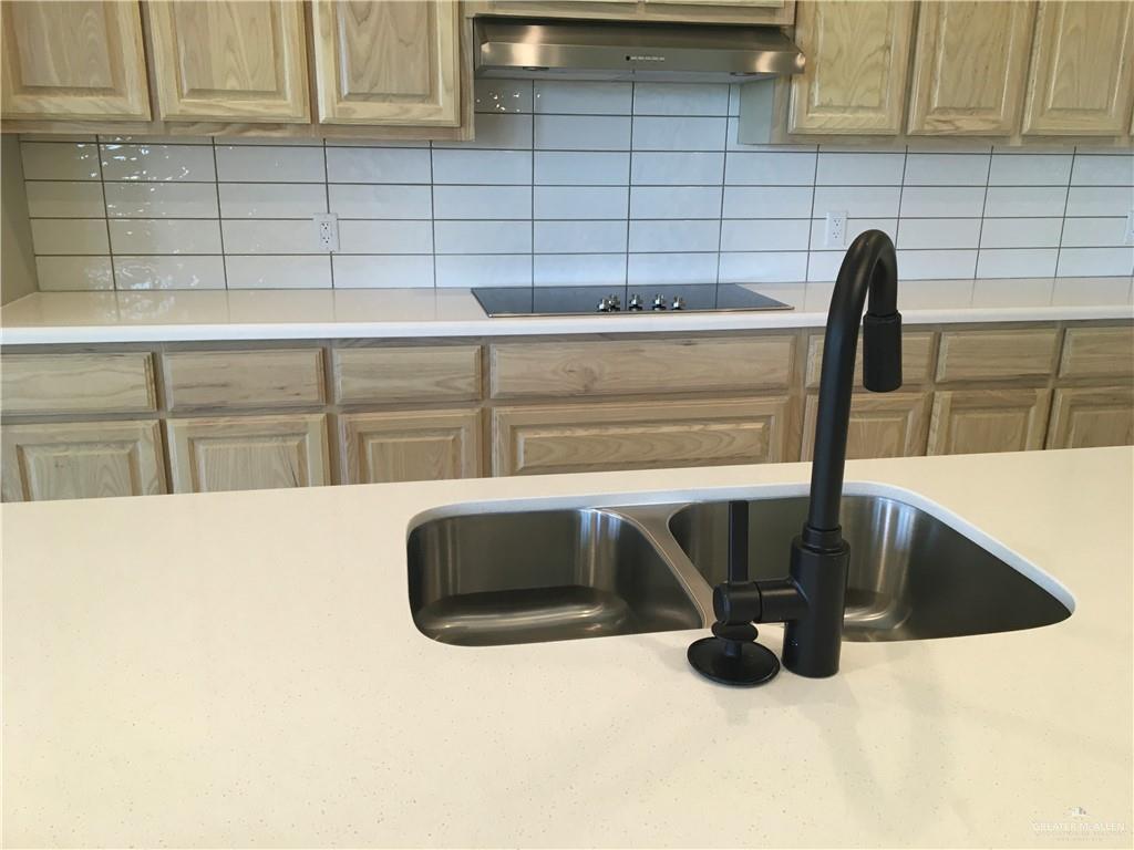 14119 Mylie Way McAllen, TX 78504 - Photo 17 of 29 a kitchen with granite countertop a sink and a stove