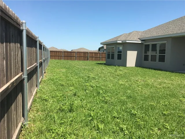 a view of a house with a backyard