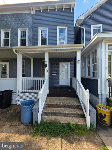 a front view of a house with stairs