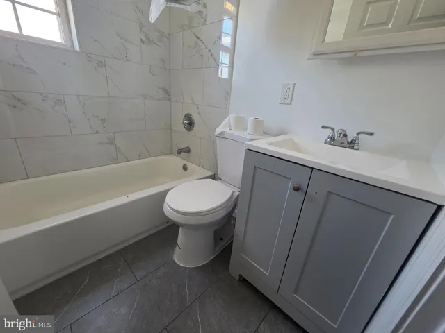 a bathroom with a sink toilet and bathtub