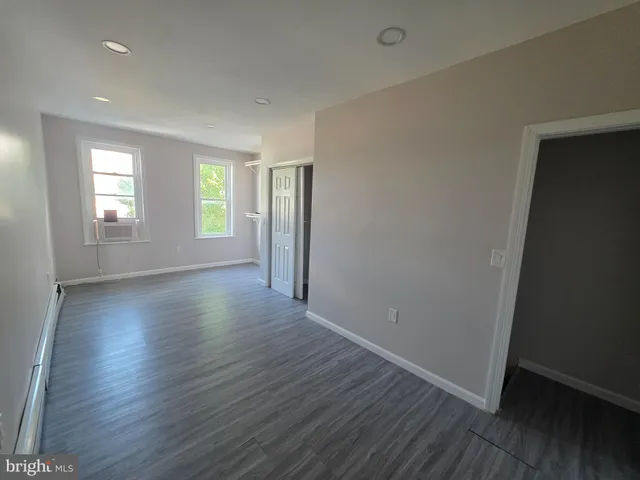 a view of hallway with wooden floor