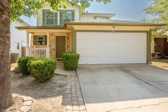 a view of a front of house with potted plants