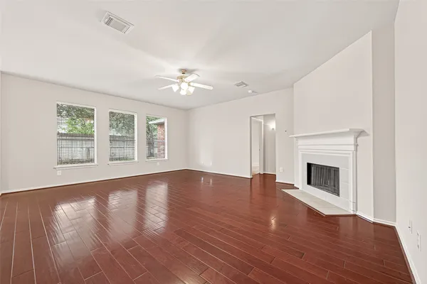 a view of a kitchen with an empty room and a fireplace