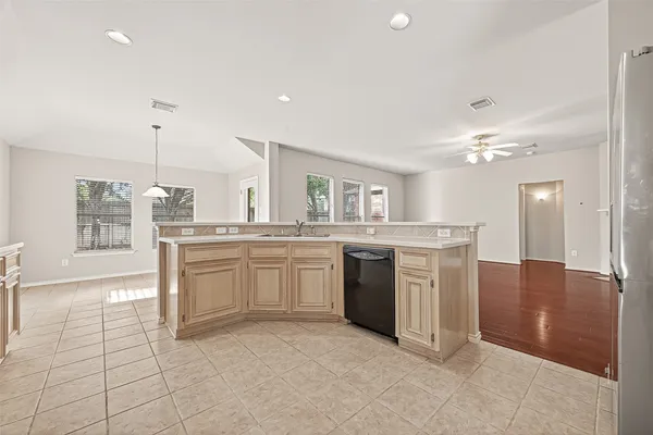 a kitchen with stainless steel appliances granite countertop a refrigerator and a sink