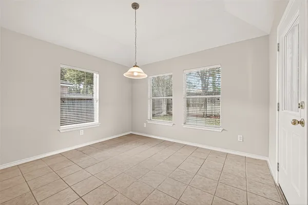 a view of a kitchen with furniture and refrigerator