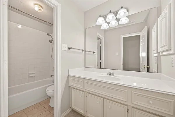 a bathroom with a shower a toilet and a shower