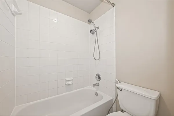 an empty room with closet and fan