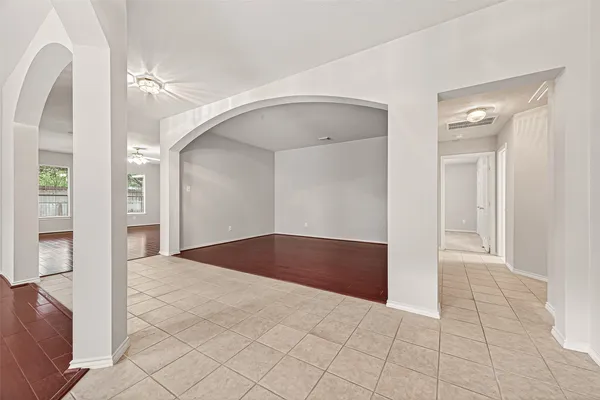 a large white room with wooden floor