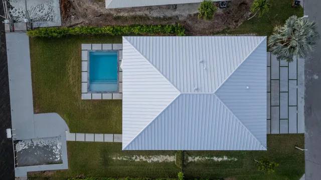a kitchen with a dining table chairs and white cabinets