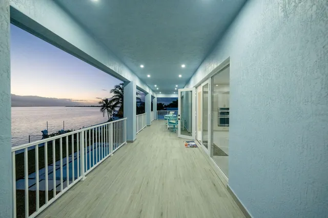a living room with furniture a window and a chandelier