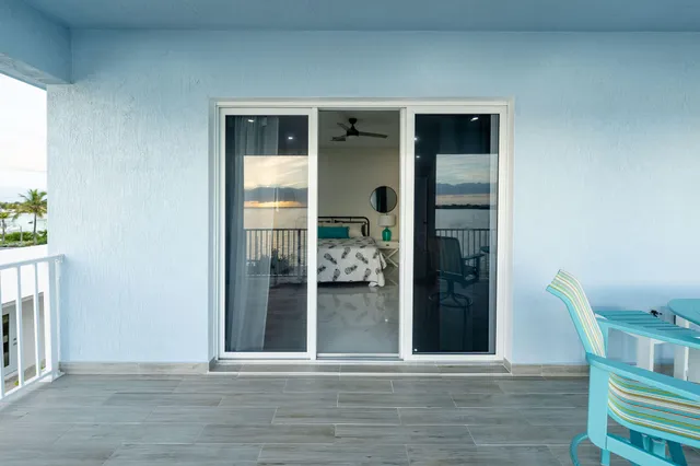 a living room with furniture kitchen view and a chandelier