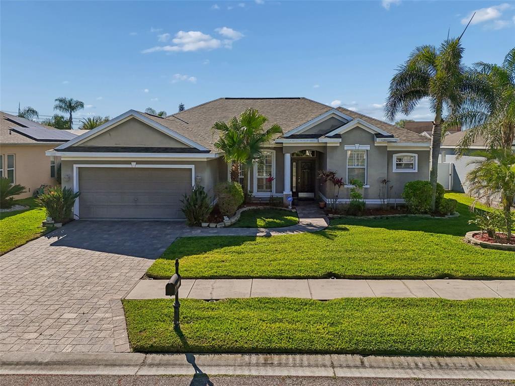 1602 Kish Boulevard Trinity, FL 34655 - Photo 1 of 65 a front view of a house with a yard