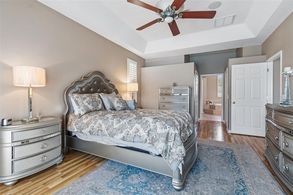 1602 Kish Boulevard Trinity, FL 34655 - Photo 16 of 65 a bedroom with a bed and a chandelier