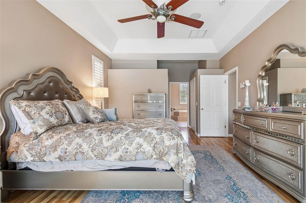 1602 Kish Boulevard Trinity, FL 34655 - Photo 17 of 65 a large bedroom with a bed dresser and wooden floor