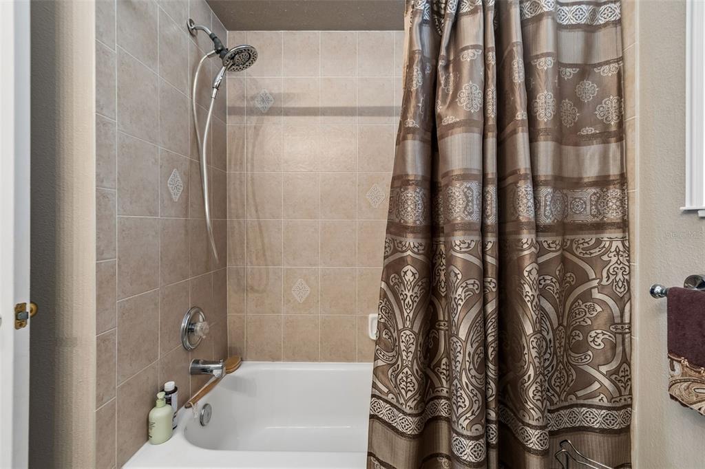 1602 Kish Boulevard Trinity, FL 34655 - Photo 33 of 65 a bathroom with a shower and a tub
