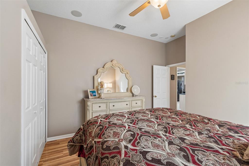 1602 Kish Boulevard Trinity, FL 34655 - Photo 38 of 65 a bedroom with a large bed and a chandelier