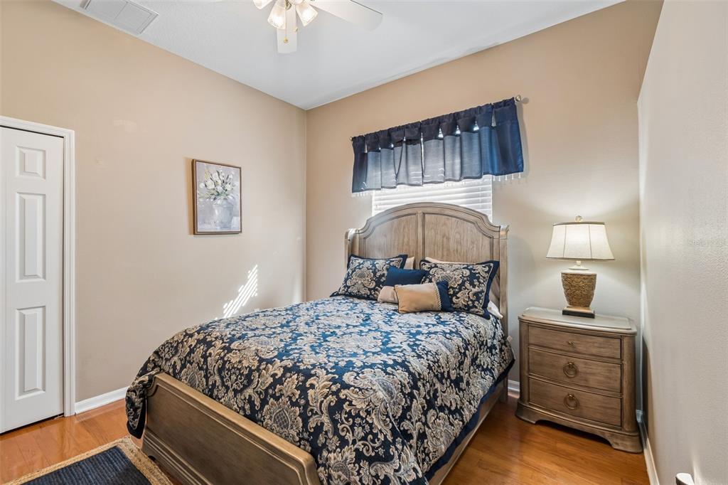1602 Kish Boulevard Trinity, FL 34655 - Photo 40 of 65 a bedroom with a bed and a chandelier