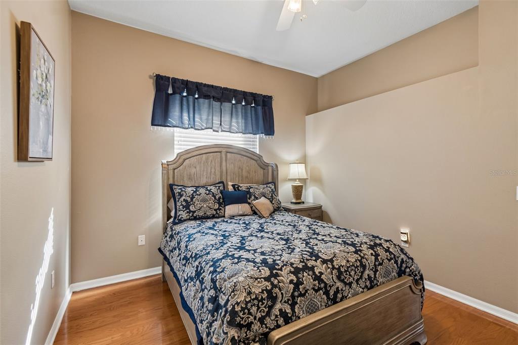 1602 Kish Boulevard Trinity, FL 34655 - Photo 41 of 65 a bed sitting in a bedroom next to a window