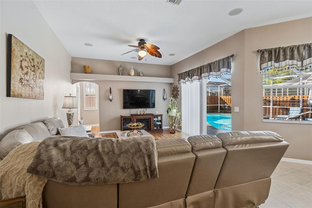 1602 Kish Boulevard Trinity, FL 34655 - Photo 44 of 65 a living room with furniture a flat screen tv and a large window