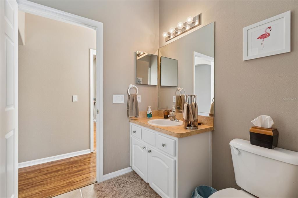 1602 Kish Boulevard Trinity, FL 34655 - Photo 51 of 65 a bathroom with a toilet sink and mirror