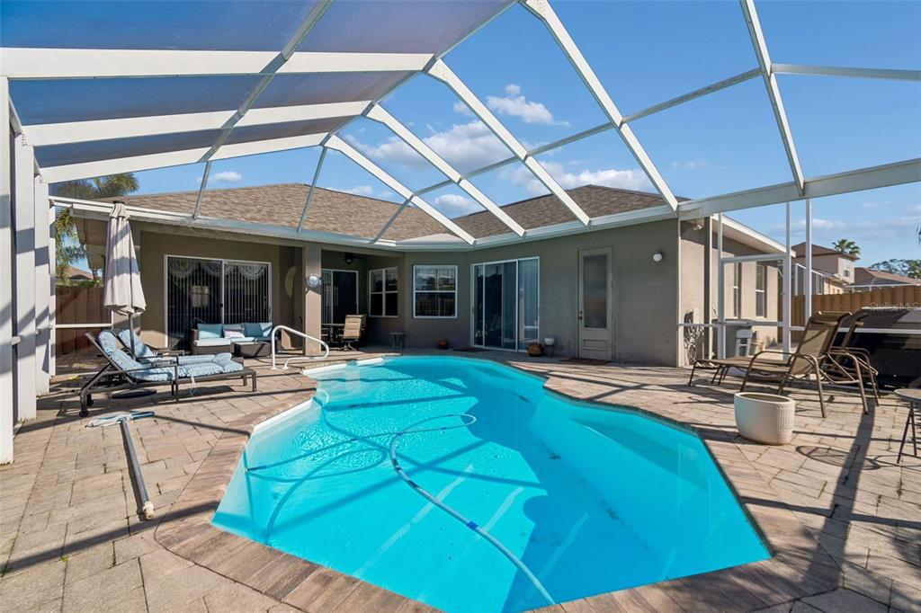 1602 Kish Boulevard Trinity, FL 34655 - Photo 59 of 65 a view of a backyard with swimming pool and sitting area