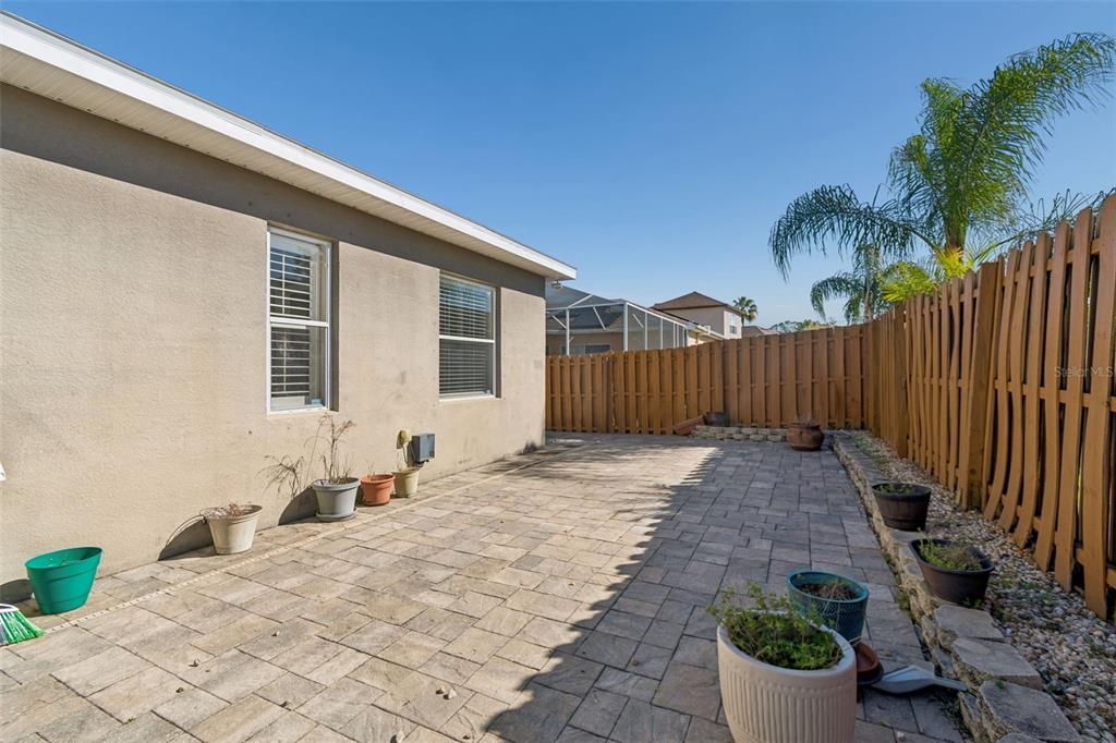 1602 Kish Boulevard Trinity, FL 34655 - Photo 60 of 65 a view of a backyard with potted plants and wooden fence