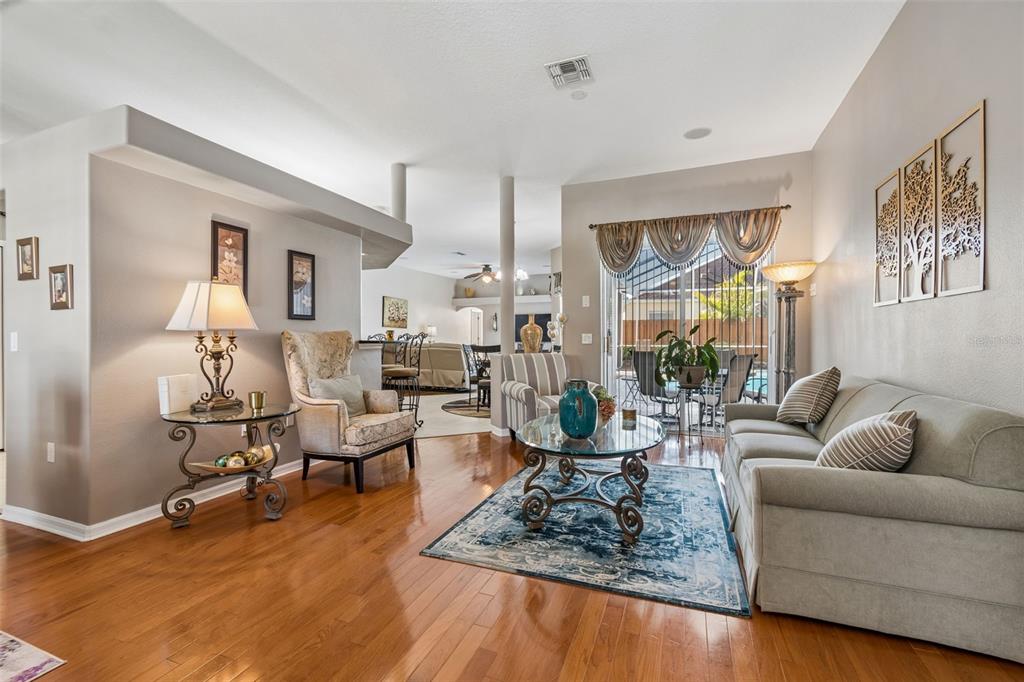 1602 Kish Boulevard Trinity, FL 34655 - Photo 8 of 65 a living room with furniture wooden floor and a large window