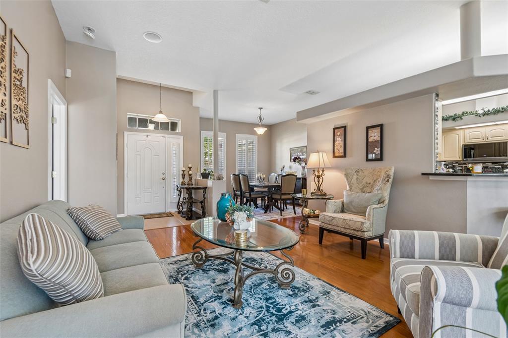 1602 Kish Boulevard Trinity, FL 34655 - Photo 9 of 65 a living room with furniture wooden floor and a view of kitchen