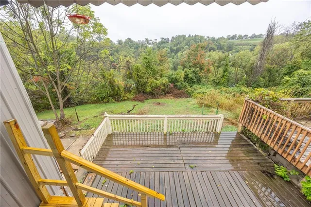 a view of balcony with wooden floor and fence