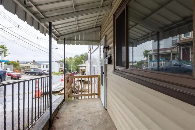 a view of a porch with wooden floor