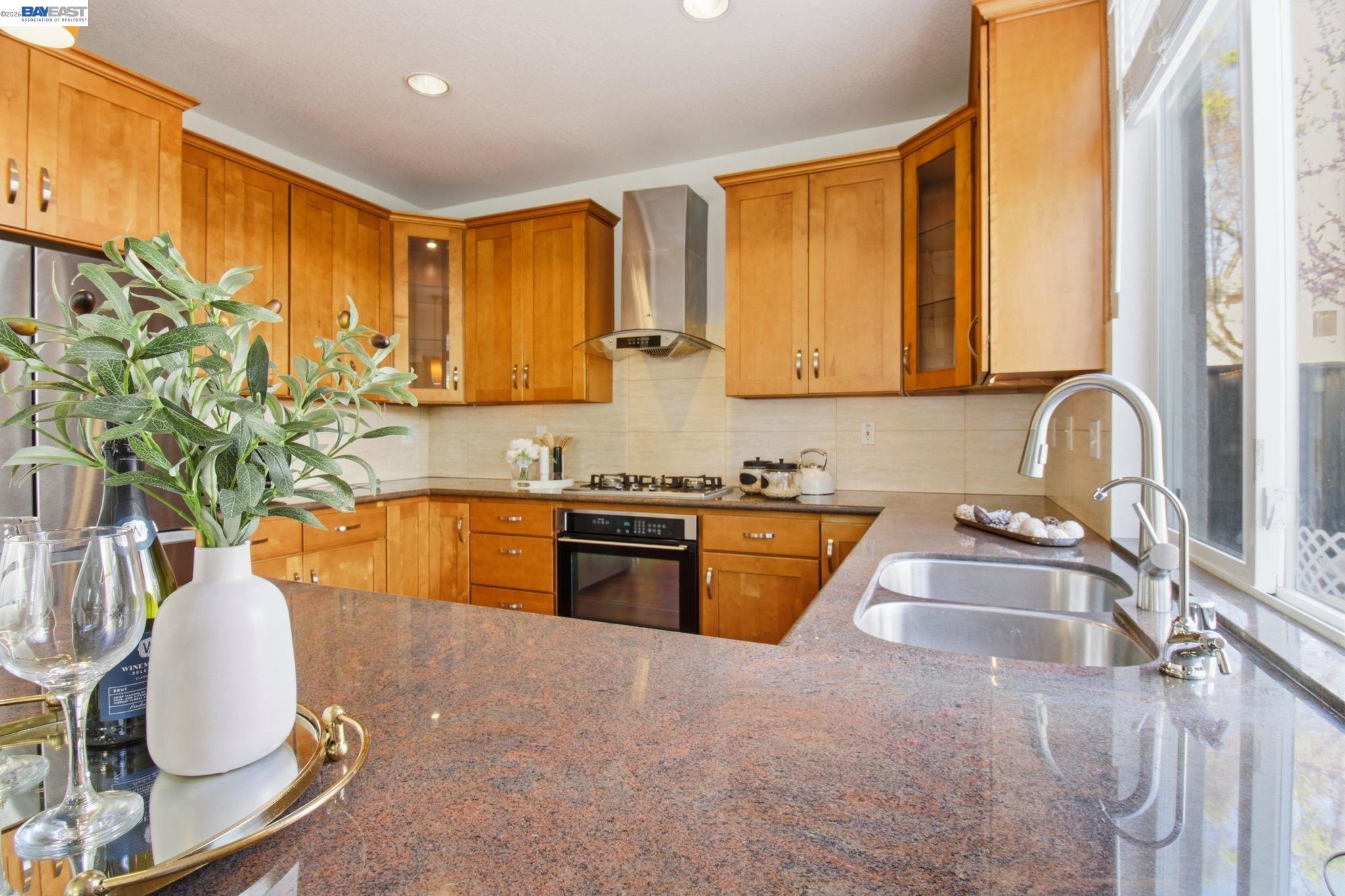 672 Greylyn Drive San Ramon, CA 94583 - Photo 14 of 35 a kitchen with stainless steel appliances granite countertop a sink a stove and a microwave