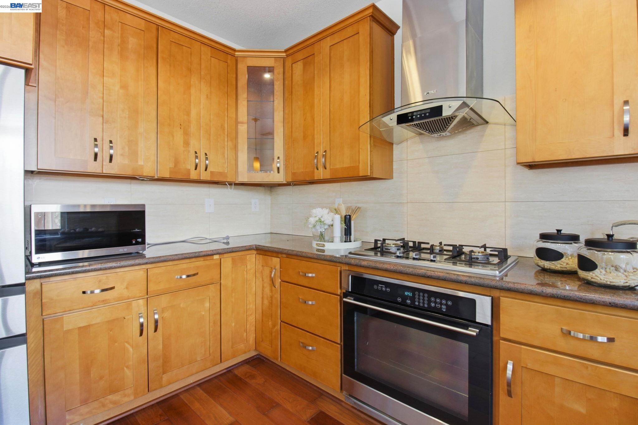 672 Greylyn Drive San Ramon, CA 94583 - Photo 15 of 35 a kitchen with granite countertop cabinets stainless steel appliances and a sink