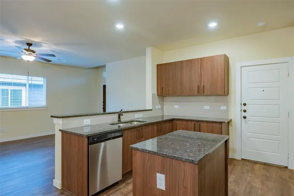 a kitchen with stainless steel appliances granite countertop a stove a microwave and a sink