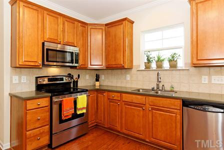 3407 Ranbir Drive Durham, NC 27713 - Photo 11 of 25 The tile backsplash and moen faucet with a goose neck pull out are wonderful features in the kitchen! Kitchen