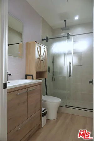 a bathroom with a toilet sink and shower