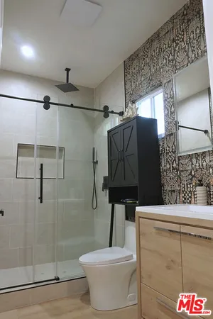 a bathroom with a sink toilet and shower