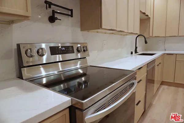 a kitchen with a sink and cabinets