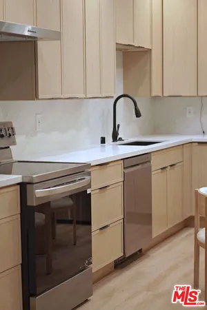 a kitchen with a sink and cabinets