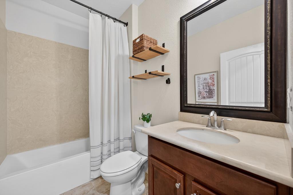 5409 Mill Water Circle Rancho Cordova, CA 95742 - Photo 24 of 48 a bathroom with a granite countertop sink a toilet and shower