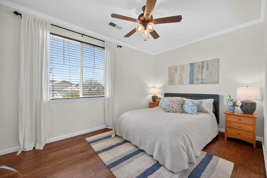 5409 Mill Water Circle Rancho Cordova, CA 95742 - Photo 29 of 48 a bedroom with a bed chandelier and a window